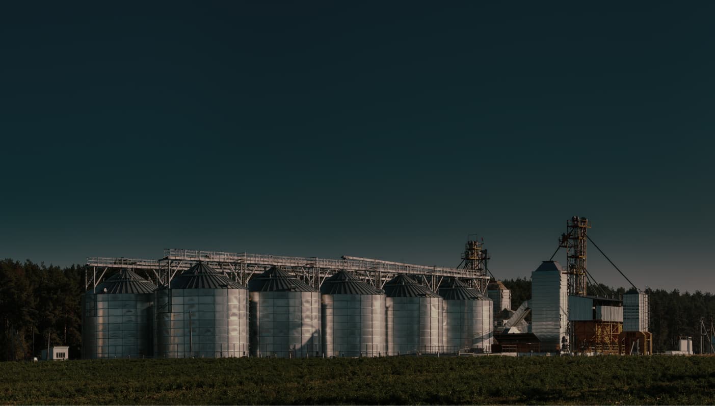 Image of the sky with silos in the background.